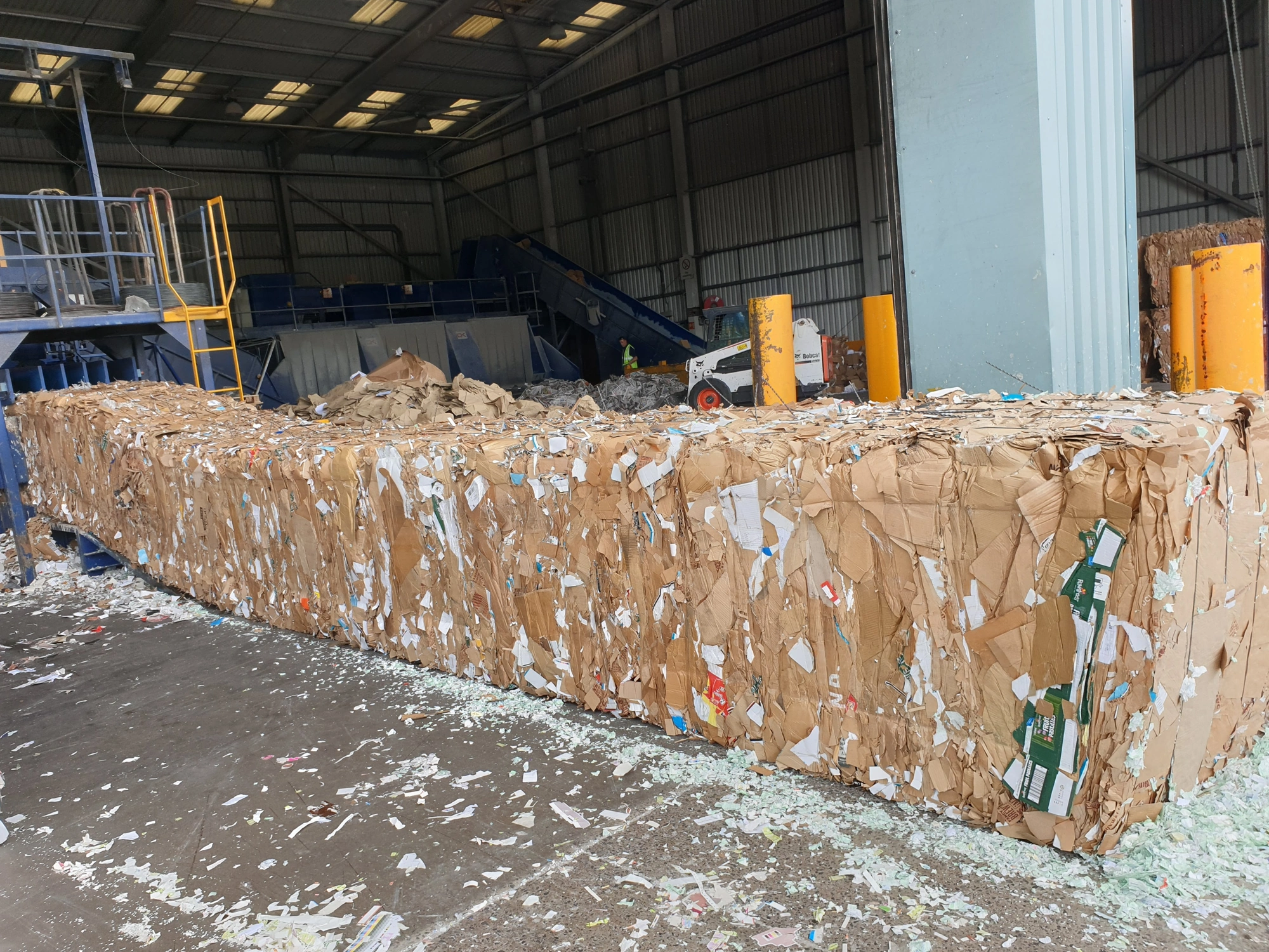 Bales of recycled cardboard at recycling depot.