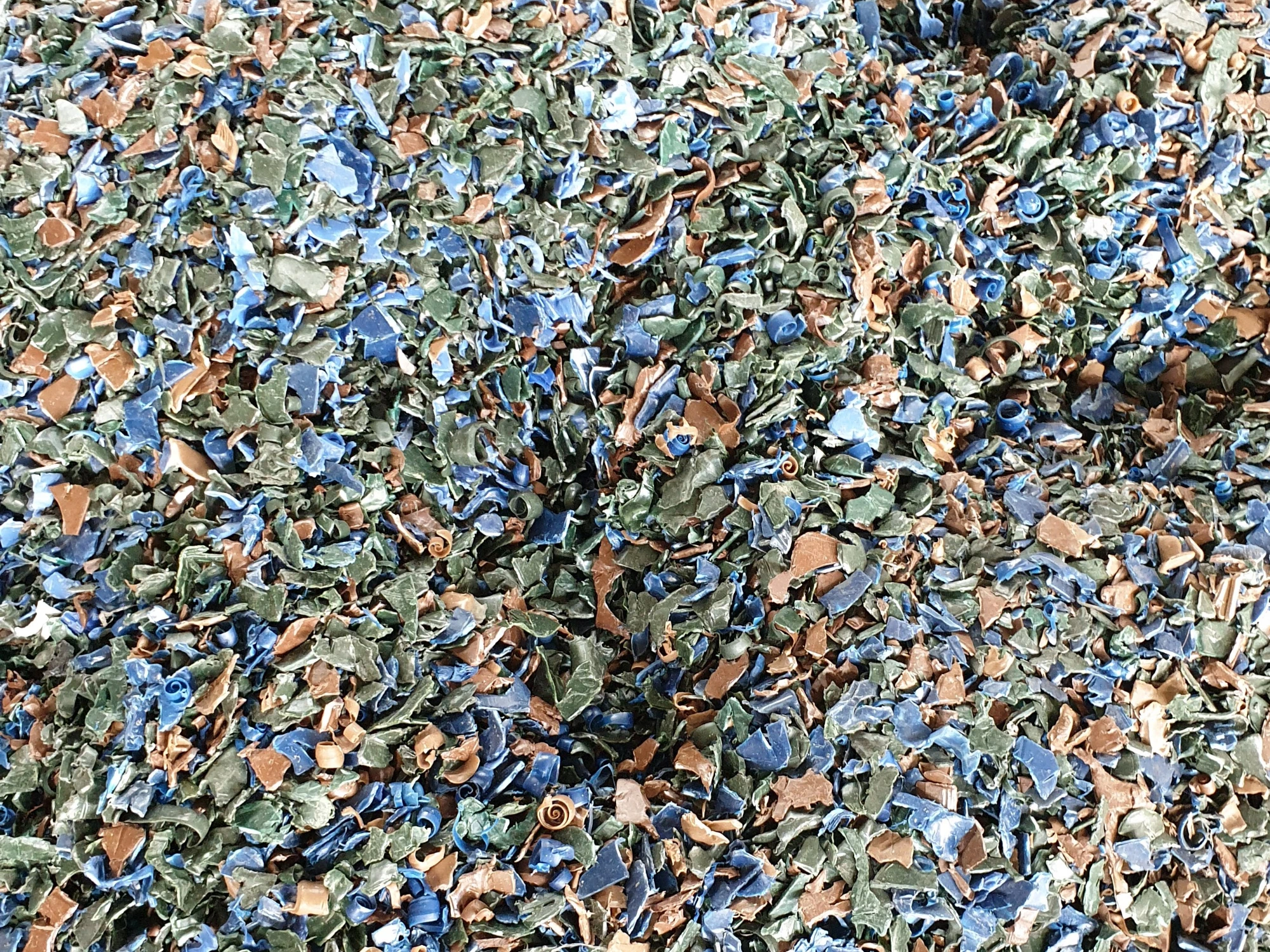 A large pile of recycled plastic flakes.