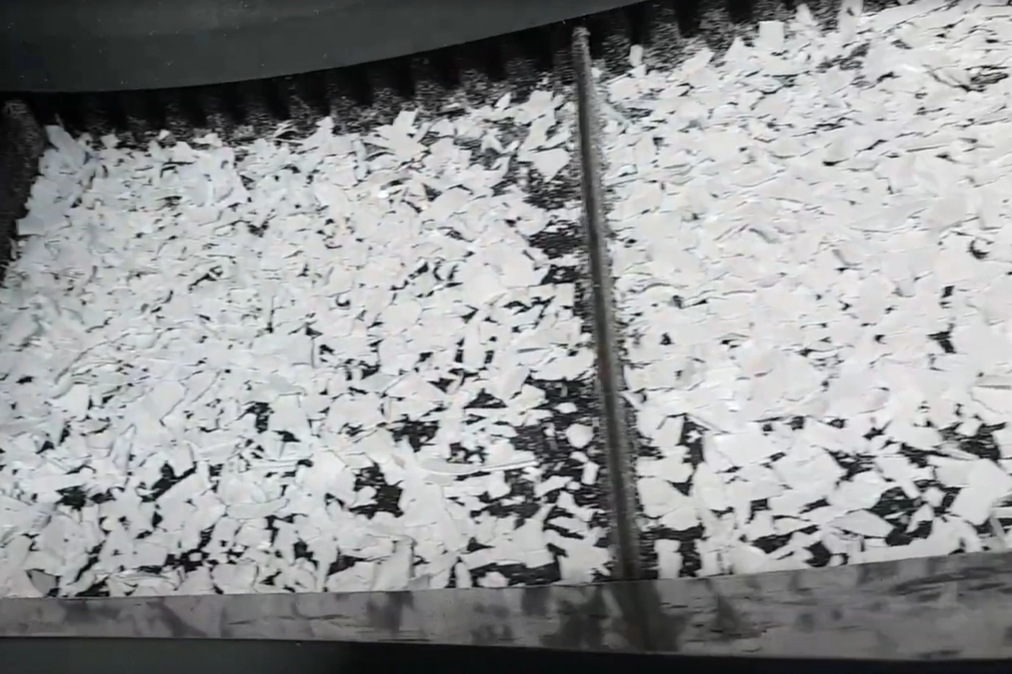 Recycled plastic flakes at a processing plant.
