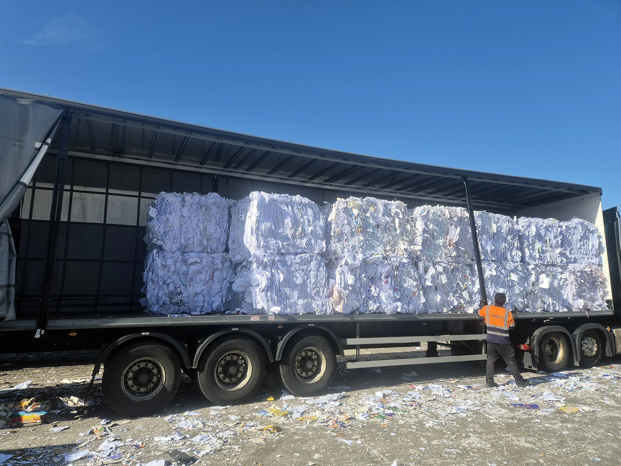 A lorry load of paper for recycling at a recycling depot.