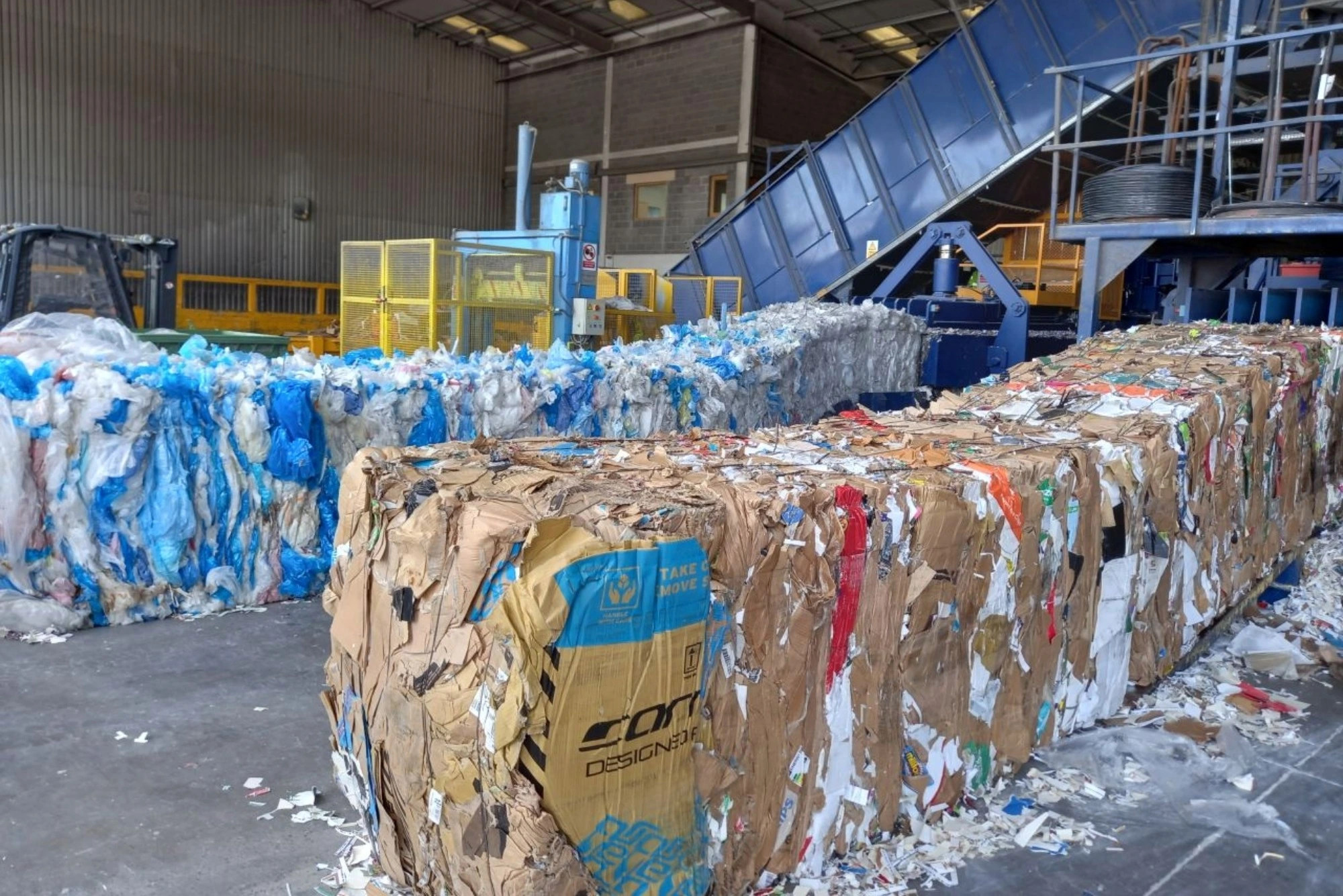 Two bales of paper and cardboard recycling.