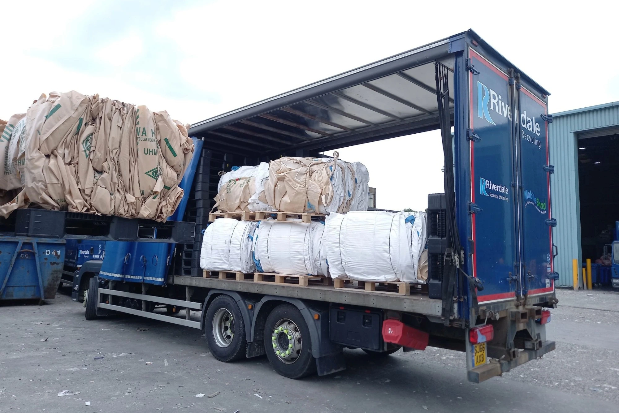 A lorry load of paper for recycling at a recycling depot.